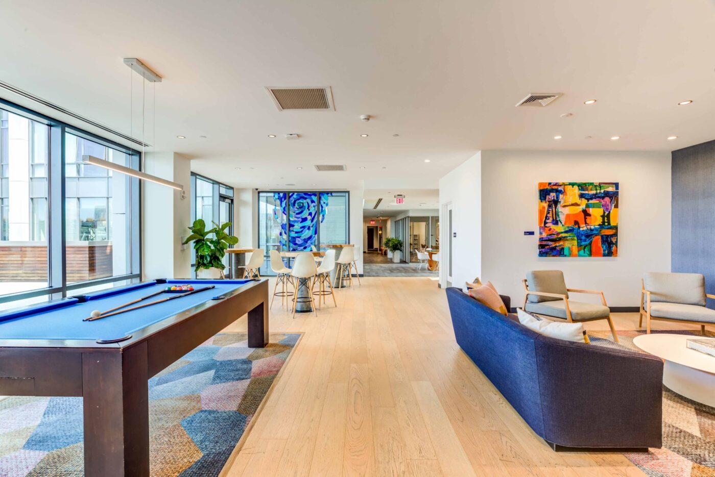 The Eddy East Boston Apartments community room with lounge seating and pool table